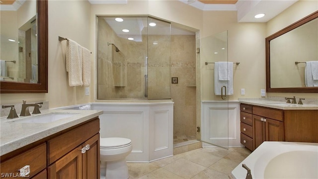 bathroom featuring toilet, ornamental molding, vanity, a shower with door, and tile patterned flooring