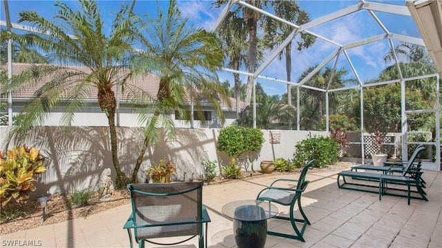 view of patio featuring a lanai