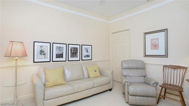 living room with crown molding and carpet