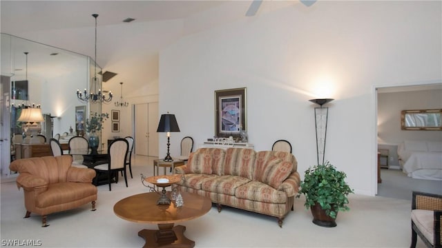 living room featuring carpet, ceiling fan with notable chandelier, and high vaulted ceiling