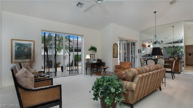 living room with ceiling fan with notable chandelier