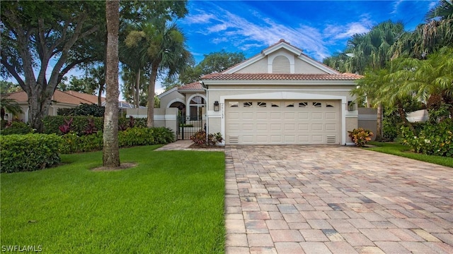 view of front of home with a garage and a front lawn