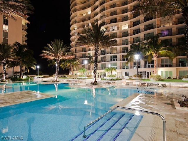 3000 Oasis Grand Blvd Unit 1704, Fort Myers, FL 33916 - pool at night with a community pool and a patio