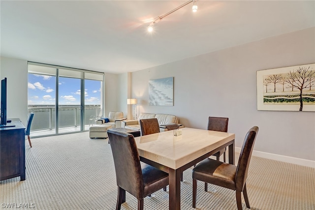 3000 Oasis Grand Blvd Unit 1704, Fort Myers, FL 33916 - dining room featuring carpet, floor to ceiling windows, rail lighting, and a water view