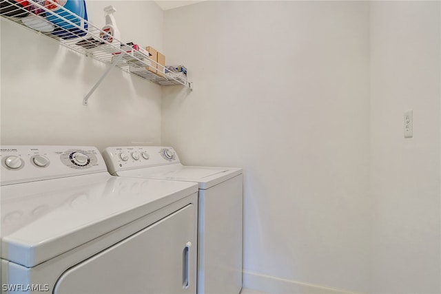 3000 Oasis Grand Blvd Unit 1704, Fort Myers, FL 33916 - washroom with washer and clothes dryer and baseboards