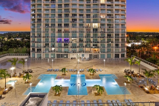 outdoor building at dusk with a community pool