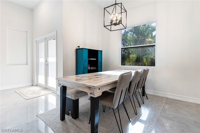 dining area featuring french doors, an inviting chandelier, and plenty of natural light