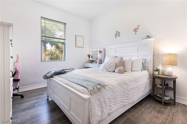 bedroom with dark hardwood / wood-style flooring