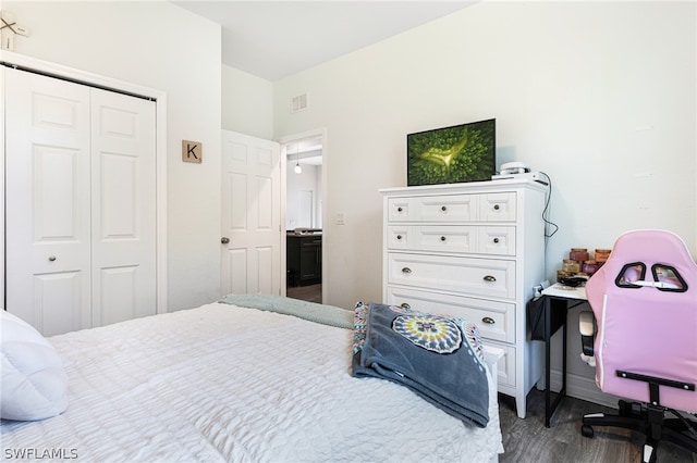 bedroom featuring a closet and dark wood-type flooring