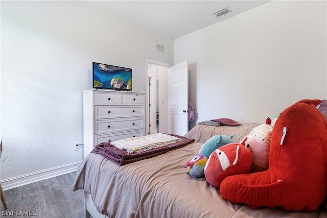 bedroom with hardwood / wood-style floors