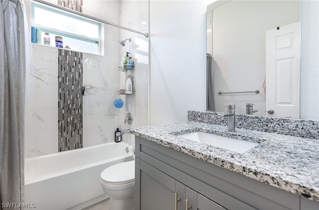 full bathroom featuring toilet, tiled shower / bath combo, and vanity