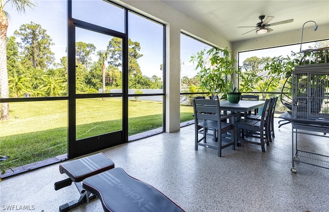 sunroom / solarium with ceiling fan and a wealth of natural light