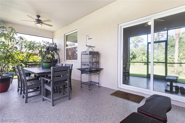 sunroom featuring ceiling fan