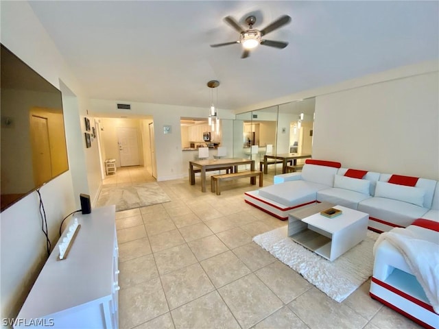 living room with light tile patterned floors and ceiling fan