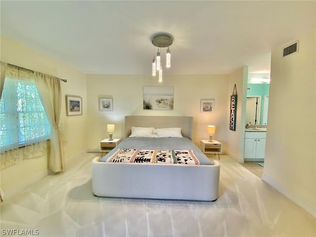 bedroom with sink, light carpet, and ensuite bath