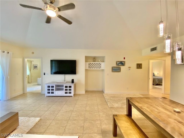 tiled living room featuring ceiling fan and vaulted ceiling