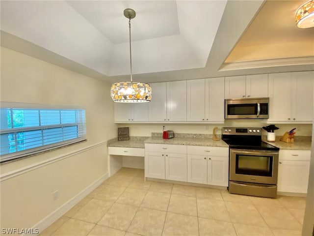 kitchen with decorative light fixtures, stainless steel appliances, a raised ceiling, and white cabinets