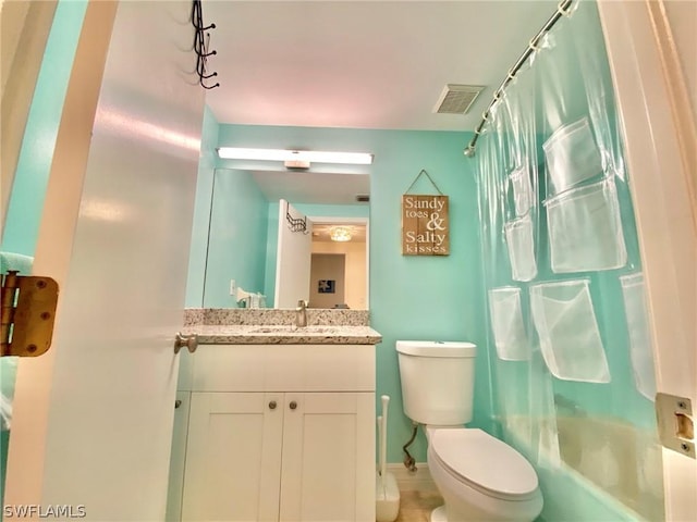 full bathroom with vanity, toilet, and shower / bath combo with shower curtain