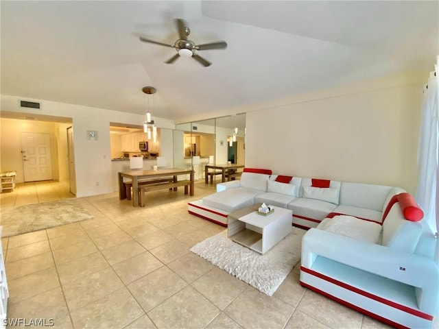 living room featuring light tile patterned floors and ceiling fan