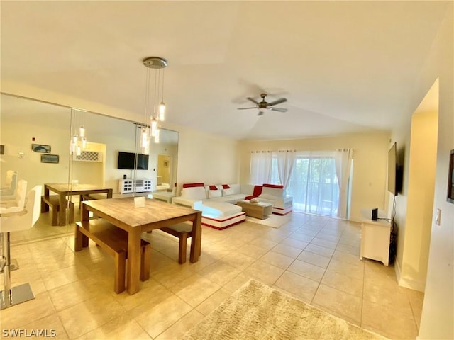 dining area featuring lofted ceiling, light tile patterned floors, and ceiling fan