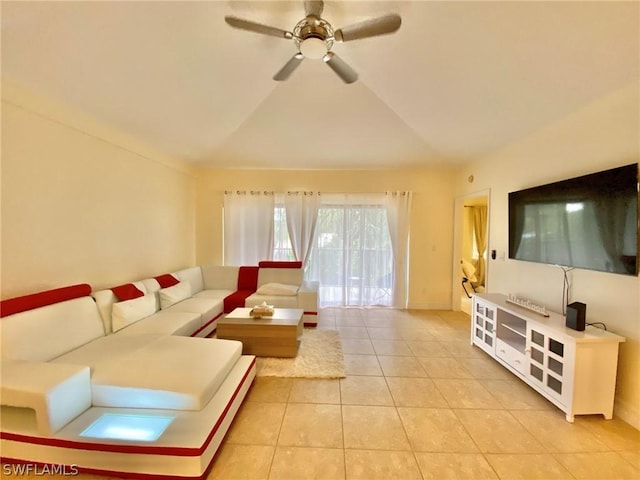 living room with ceiling fan, vaulted ceiling, and light tile patterned floors