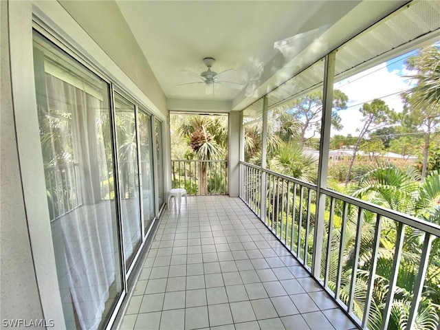 unfurnished sunroom featuring ceiling fan