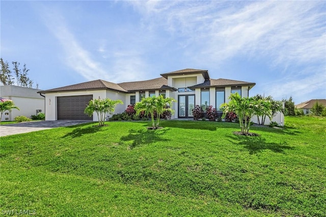 view of front facade with a garage, a front lawn, and french doors