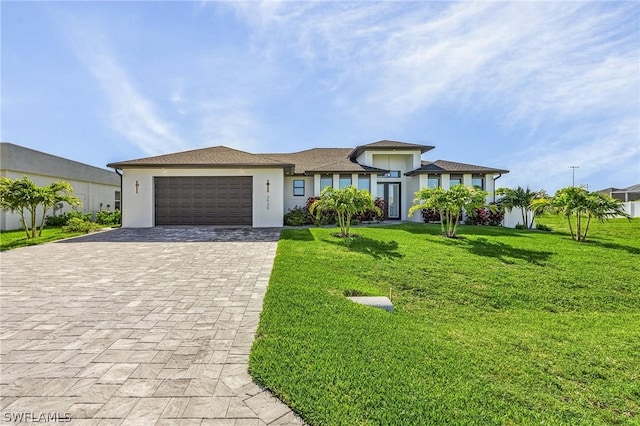 view of front of property featuring a garage and a front yard