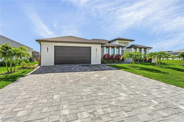 view of front facade featuring a garage and a front lawn