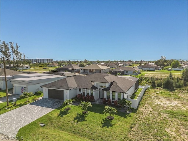 view of front of home featuring a garage and a front lawn