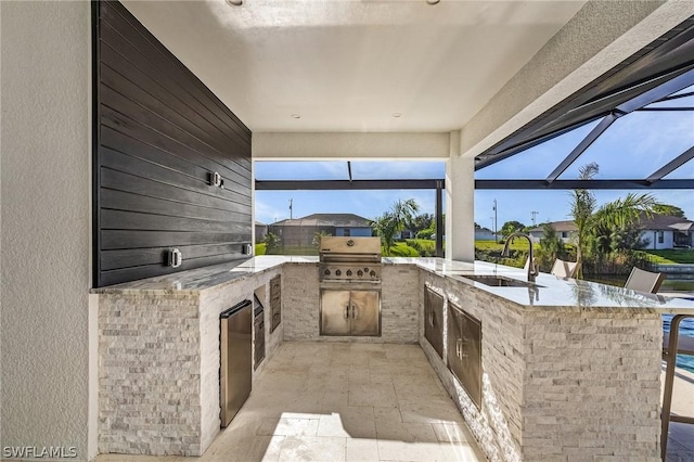 view of patio featuring a grill, a lanai, and sink