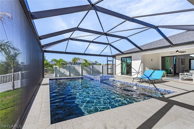 view of pool featuring an in ground hot tub, ceiling fan, a patio area, and glass enclosure