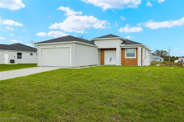 prairie-style home with a front yard and a garage