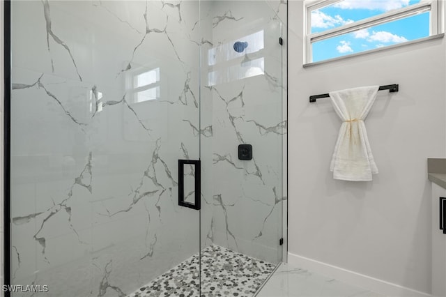 bathroom featuring a shower with shower door