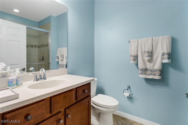 bathroom with tile patterned floors, vanity, toilet, and a shower with shower door