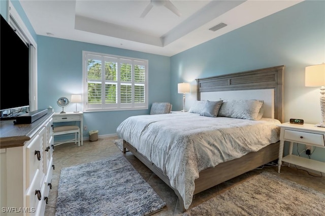 bedroom featuring a tray ceiling and ceiling fan