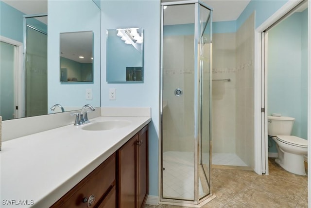 bathroom featuring walk in shower, vanity, and toilet