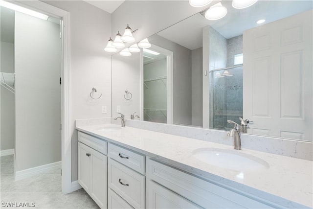 bathroom featuring vanity, tile patterned flooring, and a shower with shower door