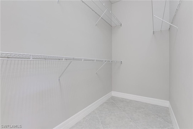 walk in closet featuring light tile patterned flooring