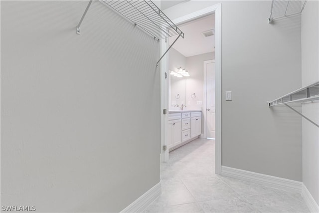 walk in closet featuring light tile patterned floors