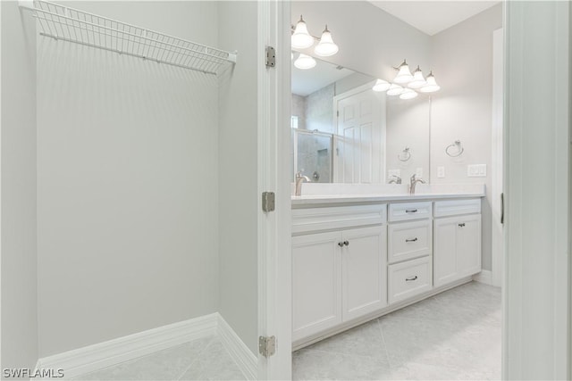 bathroom featuring vanity, tile patterned floors, and a shower with shower door