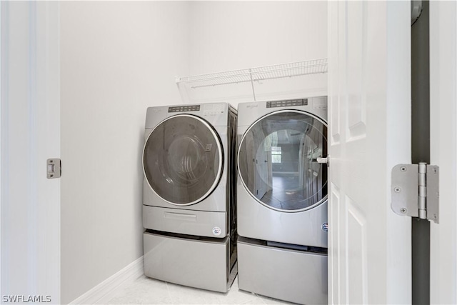 laundry room featuring washer and dryer and light tile patterned floors