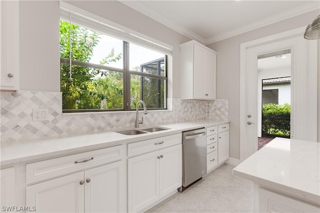 kitchen with dishwasher, a healthy amount of sunlight, decorative backsplash, white cabinetry, and sink