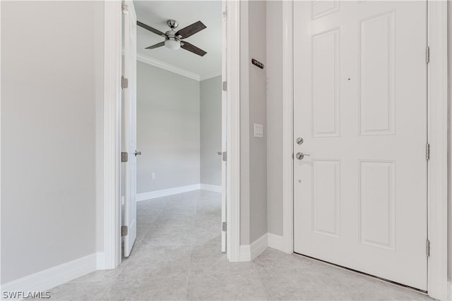 hall featuring crown molding and light tile patterned floors