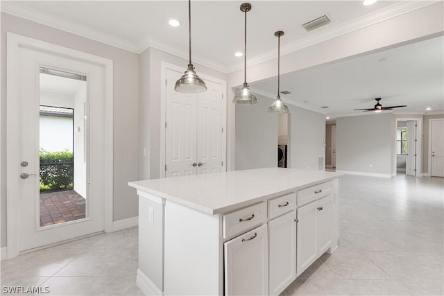 kitchen with white cabinets, a center island, ceiling fan, light tile patterned floors, and hanging light fixtures