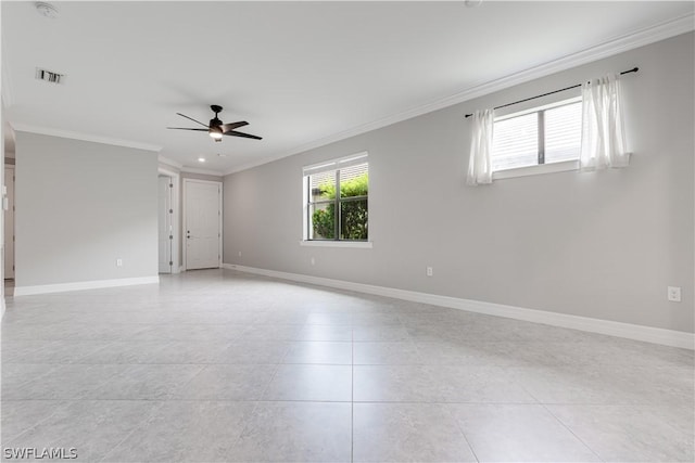 tiled spare room featuring ceiling fan and crown molding