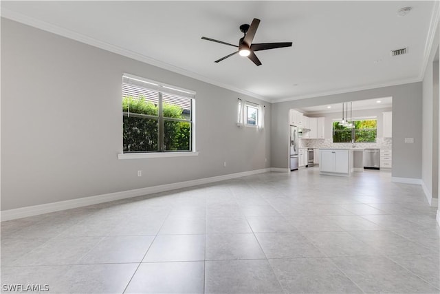 tiled spare room featuring ceiling fan, crown molding, and sink