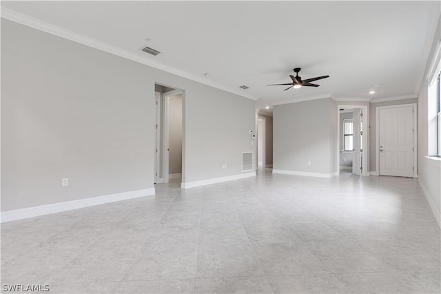 empty room featuring ceiling fan and crown molding