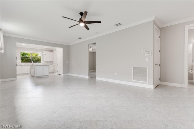 unfurnished living room featuring ceiling fan, crown molding, and sink