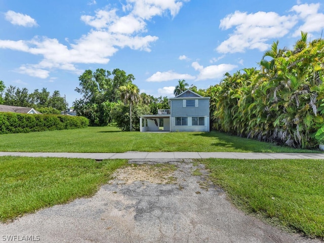 view of front of house featuring covered porch and a front lawn